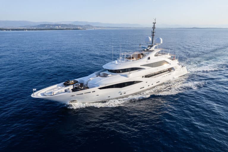 Superyacht at sea with mountains behind
