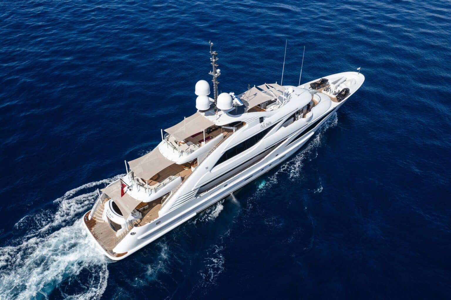 Aerial view of a superyacht under way
