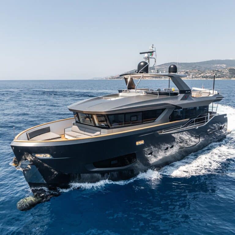 Motor yacht at sea with a second yacht behind