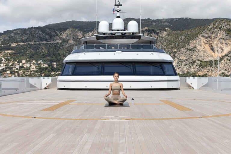 Guest relaxing on the foredeck of a yacht