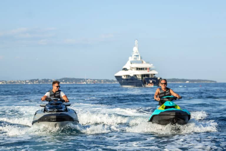 Jet skis in front of a superyacht