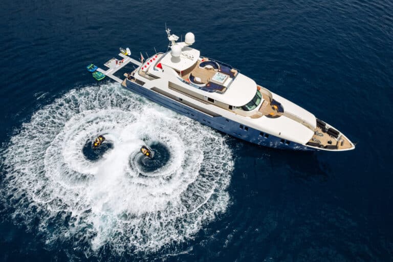 Aerial view of a yacht with jet skis