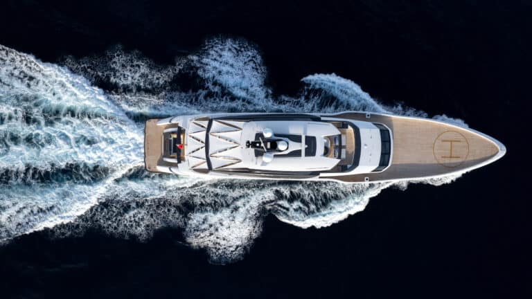 Aerial view of a superyacht at speed