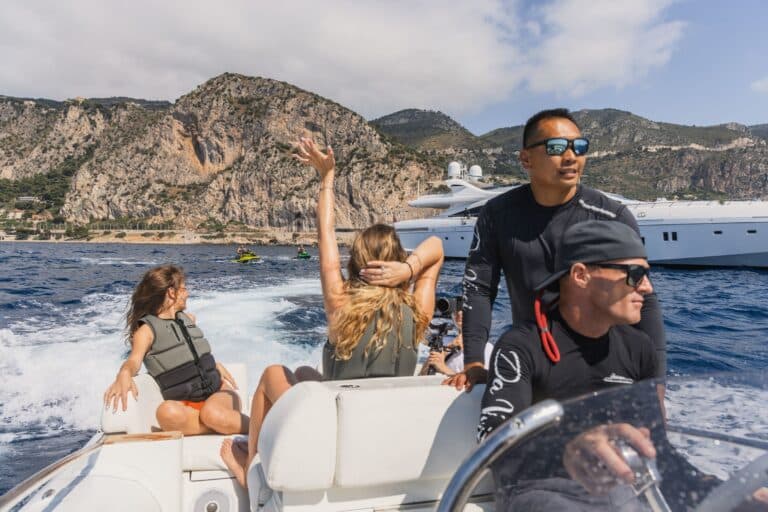 Guests on a tender with the coastline behind