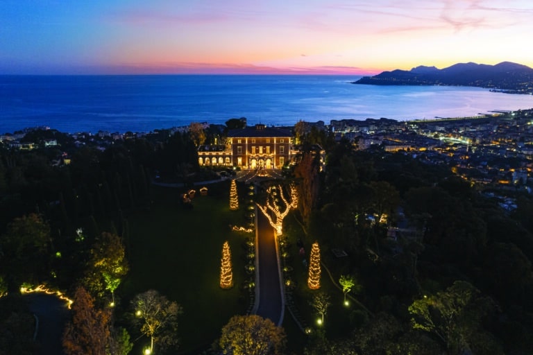 Drone view of a luxury villa lit up for the holidays